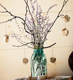 a vase filled with purple flowers sitting on top of a table