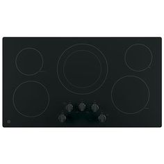 a black stove top with four burners and knobs on the front, in an angled position