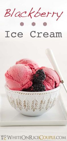 two scoops of ice cream in a white bowl with blackberries on the top