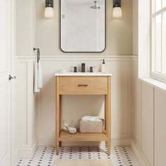 a bathroom with a sink, mirror and towel rack