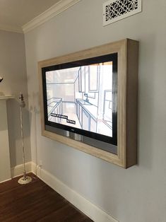 a flat screen tv mounted to the side of a wall next to a fire place