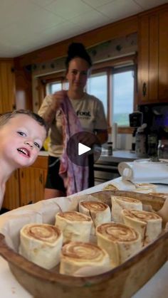 a little boy that is standing in front of some food