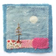 a piece of fabric with a tree on it and a moon in the sky above