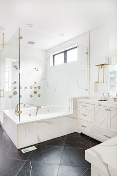 a large bathroom with marble floors and white walls, along with a walk in shower