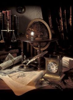 an old world globe, books, magnifying glass and other items on a table