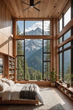 a bedroom with large windows and a mountain view outside the window is made from wood