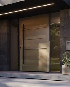 the front door of a modern house with glass and wood