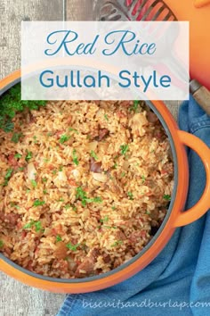 red rice with meat and vegetables in an orange pot on a blue towel next to a spatula