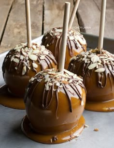 caramel apples with chocolate drizzled and almonds on top, ready to be eaten