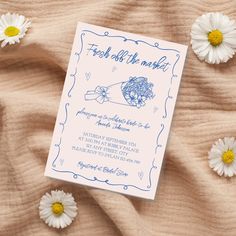 a wedding card with daisies on the bed