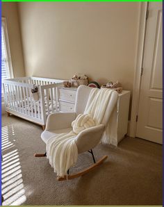 a baby's room with a rocking chair and crib