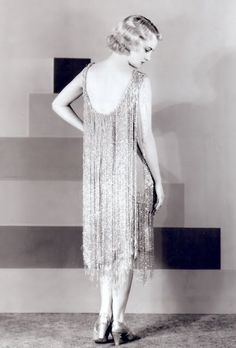 Adrian designed this fringed dress for one of the stars in Our Modern Maidens, released in 1929. Both the short flapper skirts and uneven hemlines would soon be out of style. The production cycle of filmmaking caught many movies between fashion styles in 1929. One result was the concerted effort for designing a more timeless, classical Hollywood style. 1920s Party Dress, 1920s Evening Dress, Style Année 20, Beaded Flapper Dress, 1920 Fashion, 20s Fashion, Flapper Style, 1920s Dress, 1930s Fashion