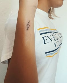 a woman with a small tattoo on her arm