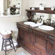 a bathroom with two sinks, mirror and stool in front of the sink counter top