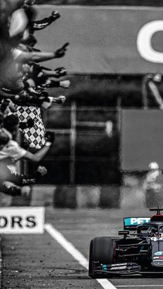 a man driving a race car on top of a track