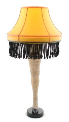 a lamp with a black and yellow shade on top of it's base,