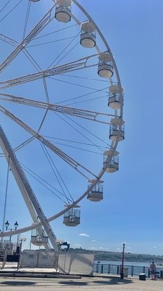 a large ferris wheel sitting next to the ocean