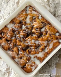 a close up of a plate of food on a lace tablecloth with a white doily