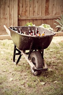 a wheelbarrow filled with lots of bottles