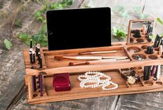 a wooden desk with makeup and other items in it on top of a wooden table