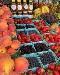 various fruits and juices on display at a market