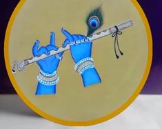 a decorative plate with a blue hand holding a flute and peacock feathers on it's head