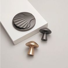 three different types of knobs in a white box on a table next to each other