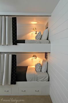 two bunk beds in a room with white walls