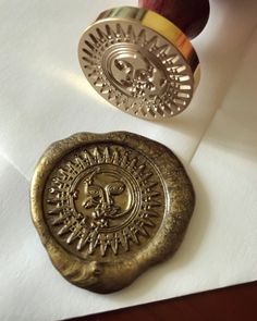 a waxed seal with an image of a lion on it next to a rubber stamp