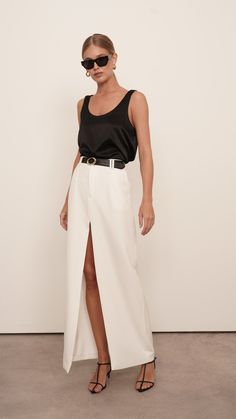 The luxury silk Isola Cami is a wardrobe staple. Constructed from high-quality silk for a relaxed fit, it adds a touch of elegance to any outfit. Perfect for day-to-night dressing, it will become a go-to piece. Styled with our Gretta pants. 100% Silk Dry Clean only White Silk Top Outfit, Silk Cami Outfit, Silk Pants Outfit, Linen Skirt Outfit, Silk Top Outfit, Silk Skirt Outfit, White Silk Top, White Linen Skirt, White Pants Outfit