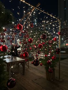 christmas decorations are hanging on the roof of a building in front of a cityscape