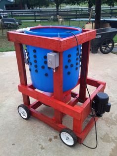 a blue bucket sitting on top of a red cart