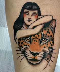 a woman and a tiger tattoo on the leg, which has been done by an artist