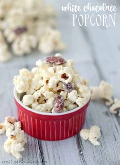 white chocolate popcorn with raisins in a red bowl