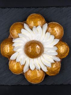 a flower made out of gold and white chocolates