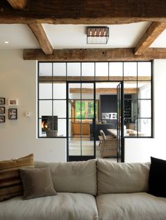 a living room filled with furniture and lots of windows