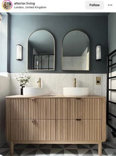 an image of a bathroom setting with two sinks and large mirrors on the wall above them