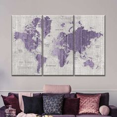 a living room with purple couches and a large map on the wall above it