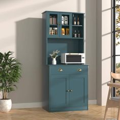 a kitchen cabinet with a microwave on the top and shelves above it, next to a potted plant