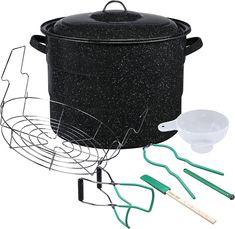 an outdoor cooking set with pots and utensils