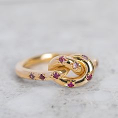 Our Pretzel Ring is a knotted band star set with shades of pink sapphires and rubies. Band width 2.5mm. Approximate weights: 4.9g in 9ct, 5.8g in 14ct, 6.6g in 18ct. Pictured with a matte finish. Please leave a note at checkout for high shine finish. Pink Ring, Shades Of Pink, Ruby Ring, Caicos Islands, Pink Sapphire, Gift Ideas, Rose Gold, Shades, Band