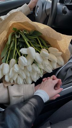 a bunch of flowers that are sitting in the passenger's seat of a car