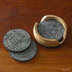 two wooden coasters sitting on top of a wooden table