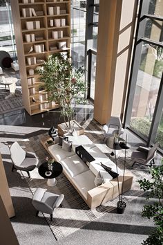 an aerial view of a living room with couches, chairs and bookshelves