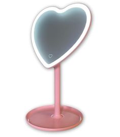 a heart shaped mirror on a pink stand