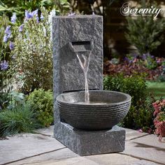 a water fountain in the middle of a garden