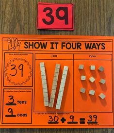 an orange sign that says 39 show it four ways and some white blocks are on the table