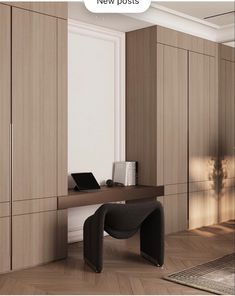 a desk with a laptop computer on top of it in front of some wooden cabinets