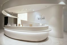 a curved white counter in the middle of a room