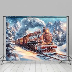 a christmas train is coming down the tracks in front of a snowy mountain scene wall mural